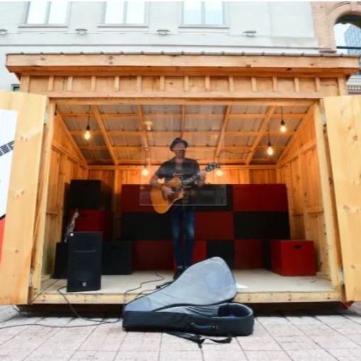Ottawa musician Shawn Tavenier performs from behind a sheet of plexiglass during an outdoor performance on the Sparks Street Mall in Ottawa on Tuesday, Aug. 4, 2020.